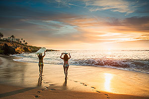 Surfers at Zuma beach at sunset