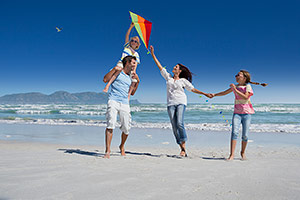 Family flying kite on beach